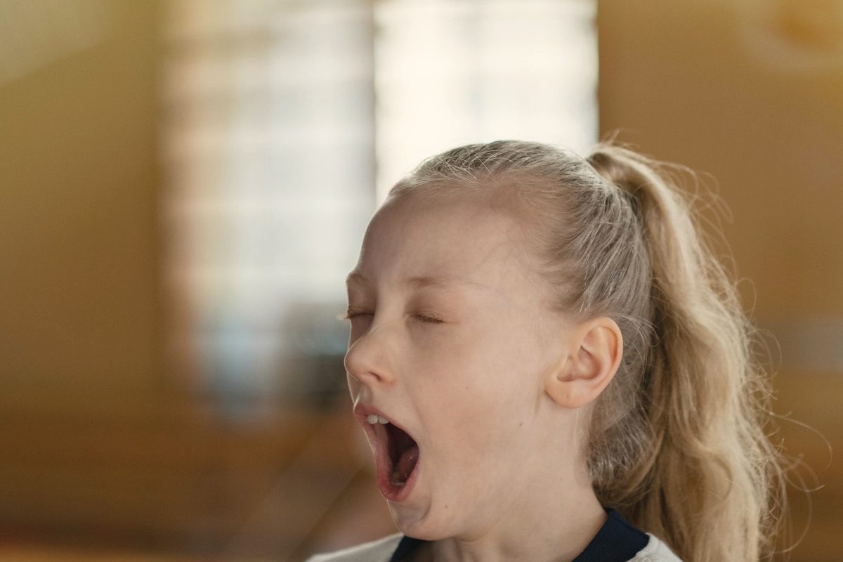 Young girl yawning in the afternoon