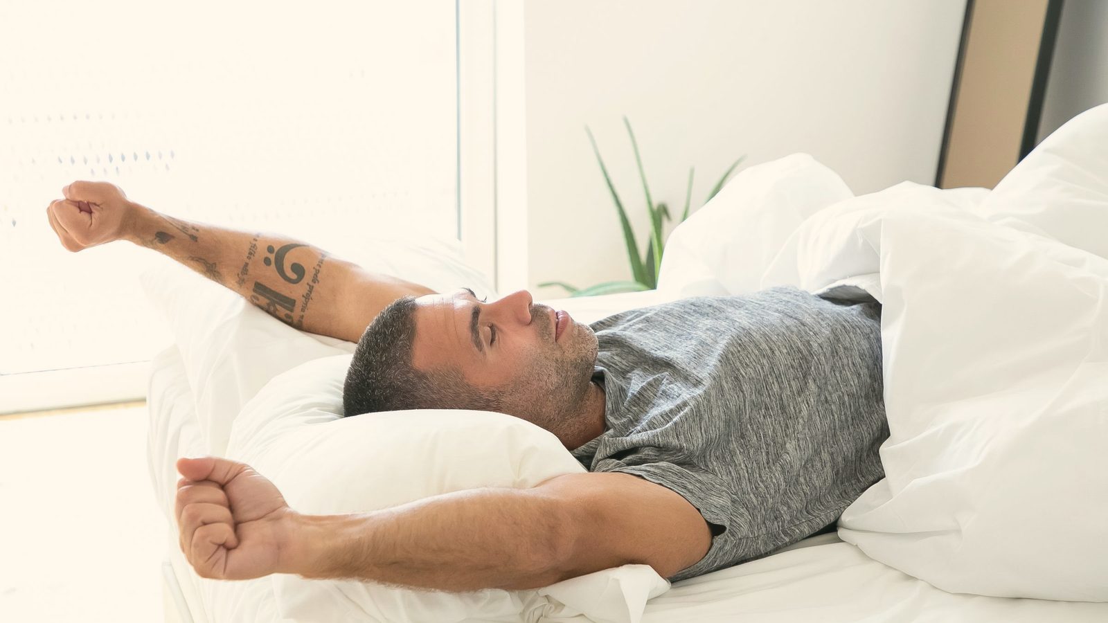 Man in gray shirt waking up