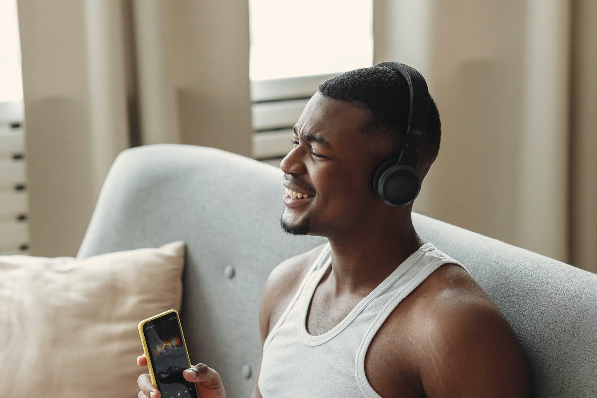 Man relaxing on a sofa with headphones