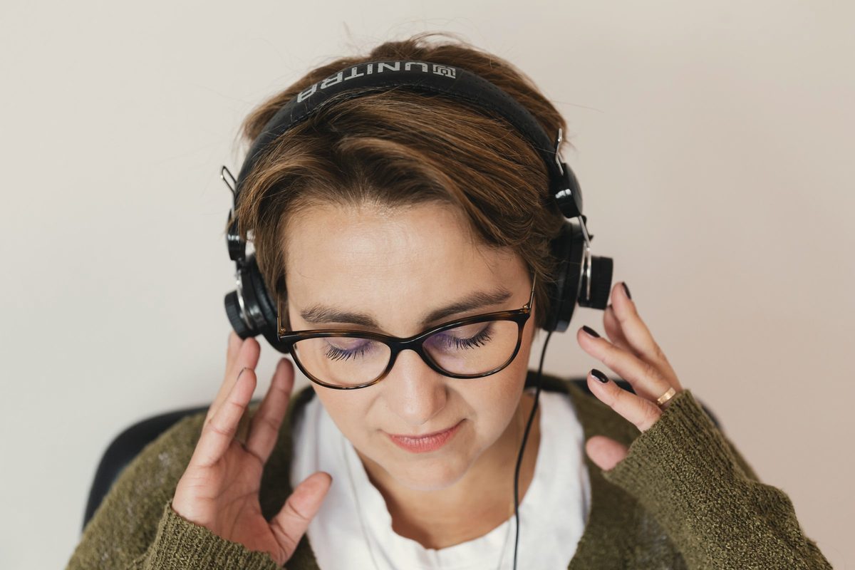 Content woman listening to music via headphones