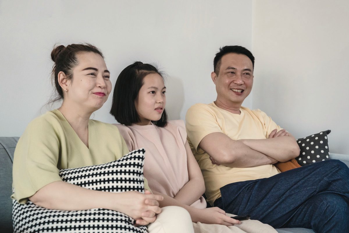 Family smiling together on a sofa
