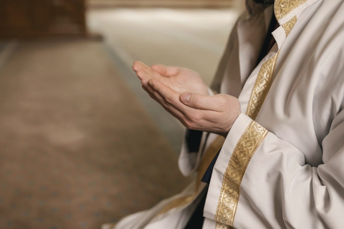 Person praying with hands raised