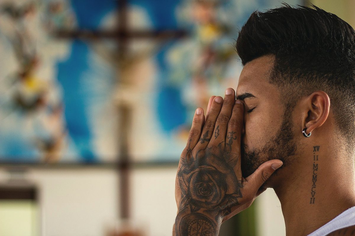 Closed eyed man holding his face using both of his hands