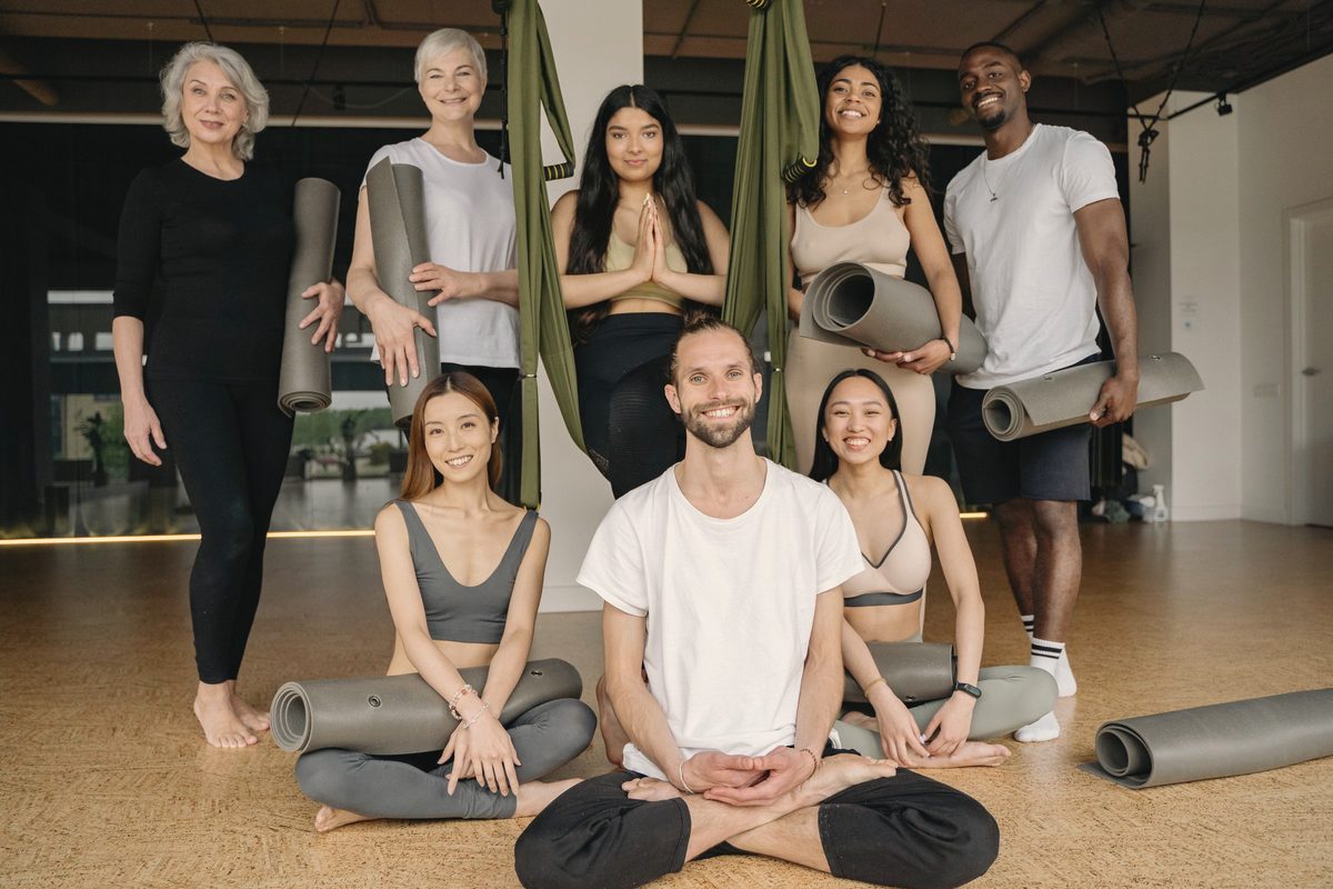 Group sitting together on the floor of a yoga studio