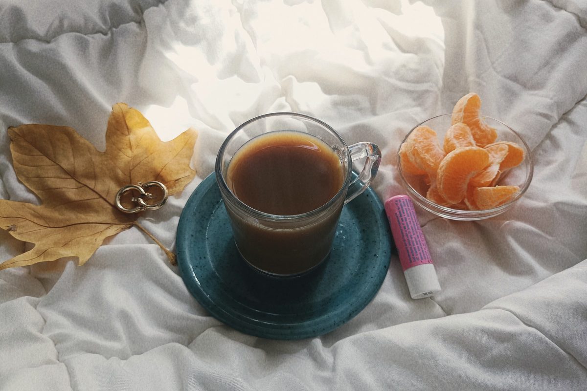Morning coffee and fruit on soft bed linen