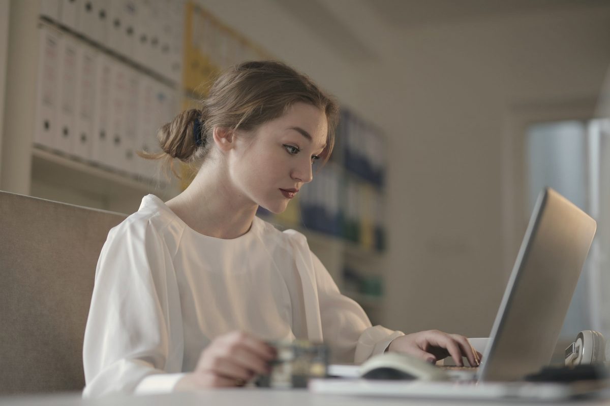 Focused young woman working on her laptop