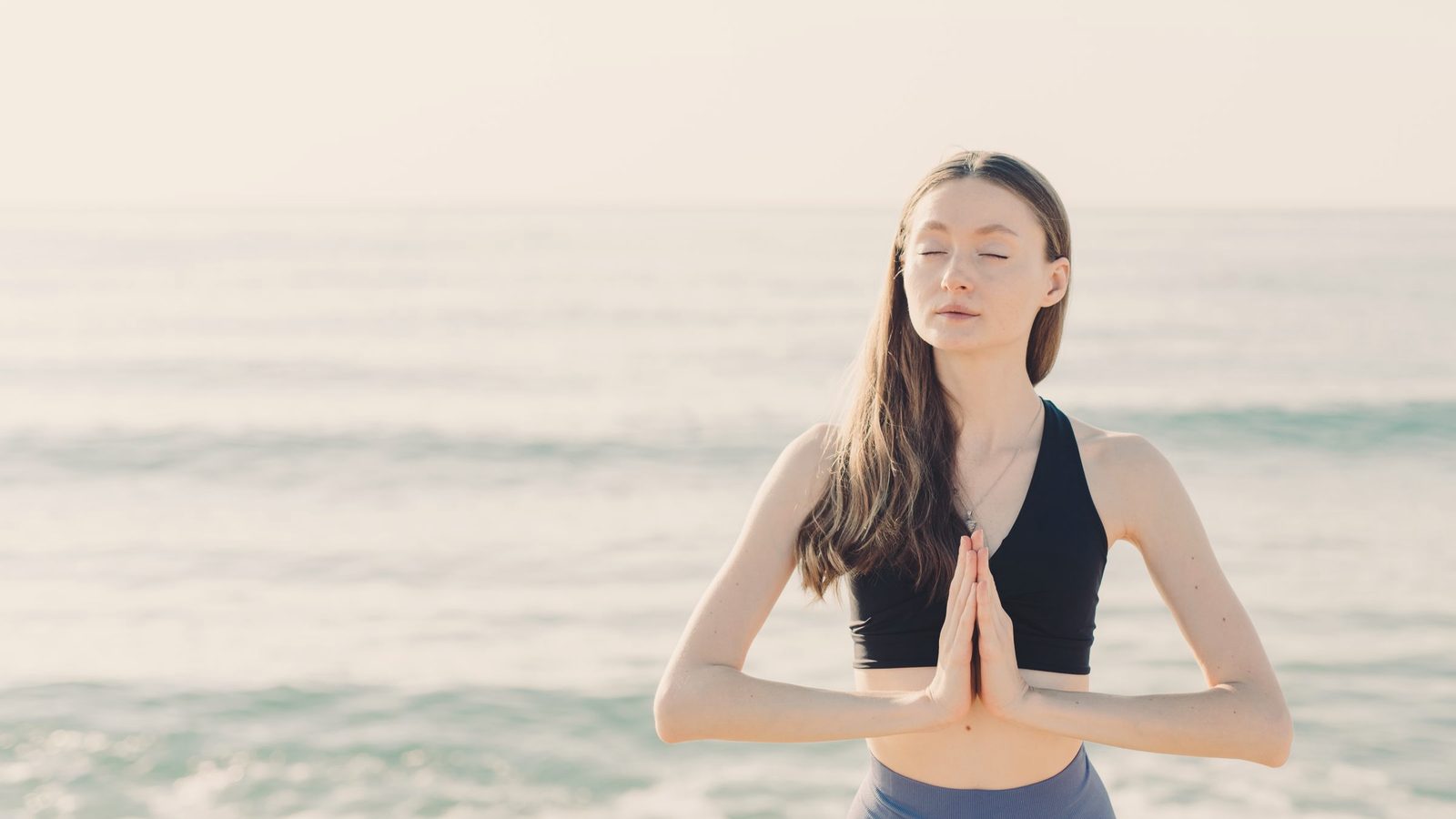 Woman meditating by the sea