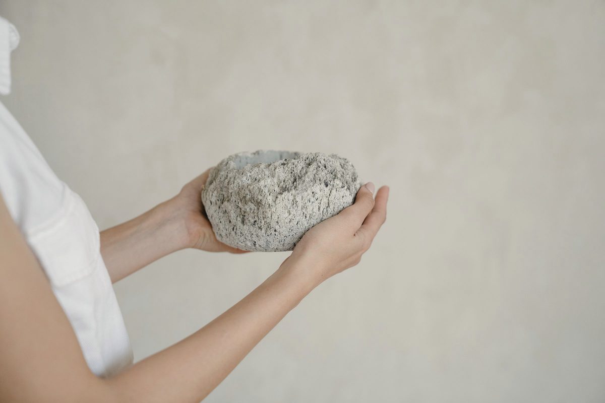 Person holding a smooth stone in both hands