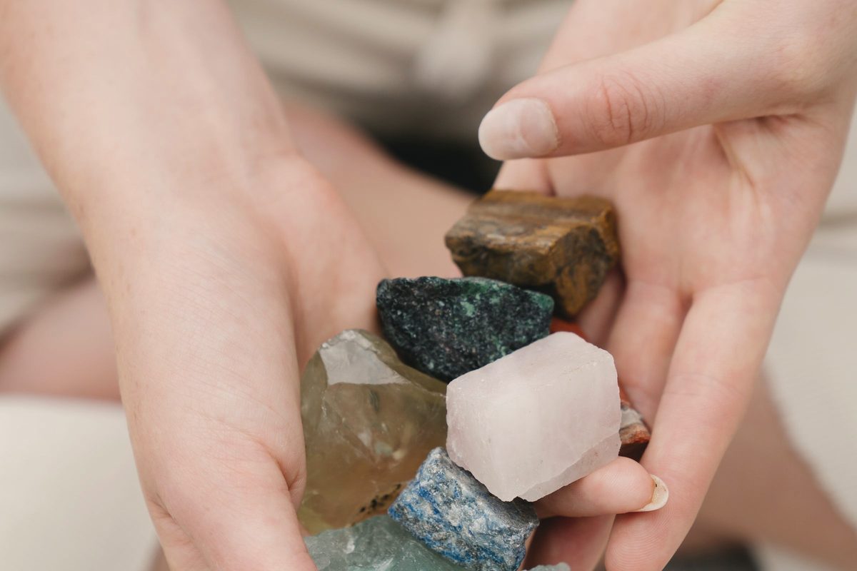Hands holding a small collection of stones