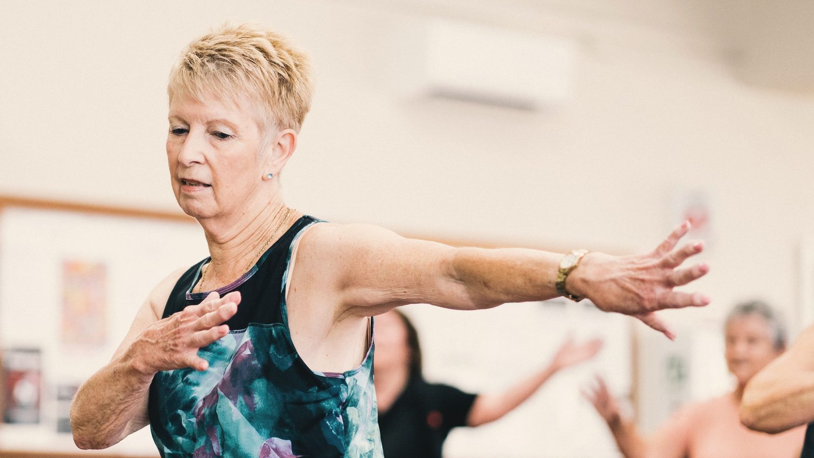 Older woman dancing with her arms outstretched