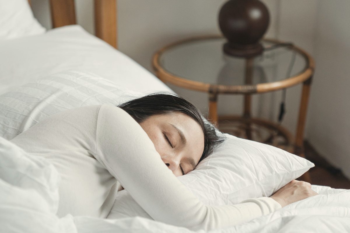 Young woman sleeping in comfy bed