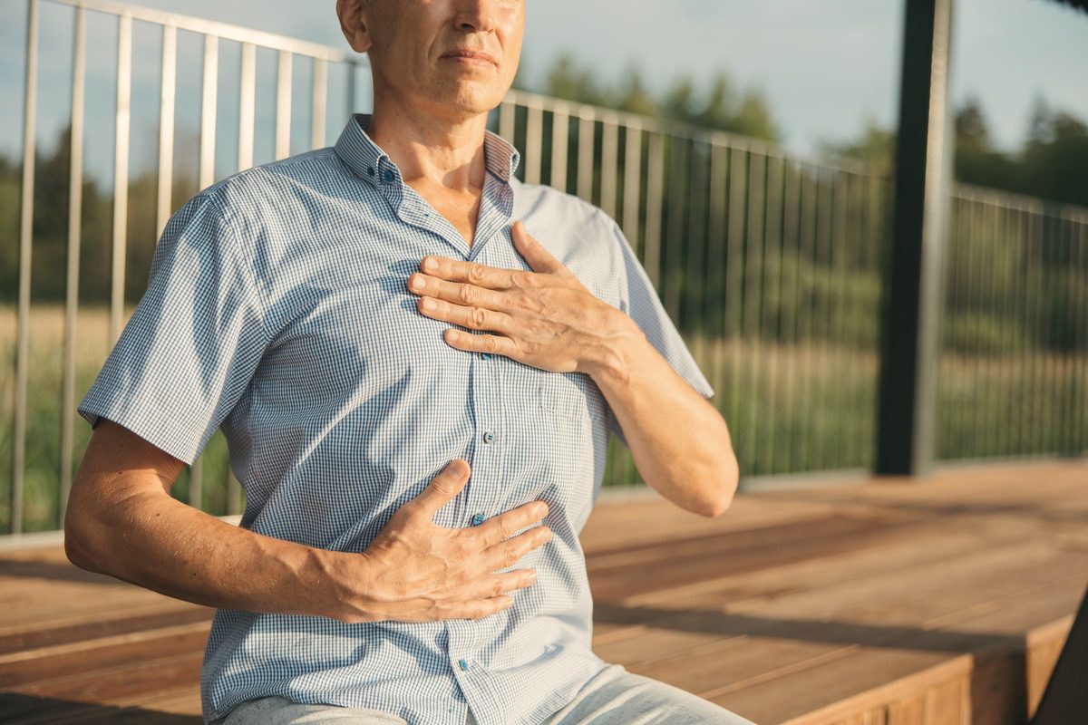 Man resting his hands on his chest