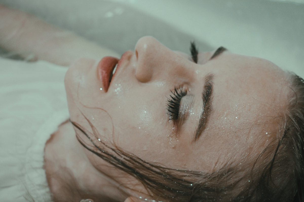 Woman relaxing in bathtub with water
