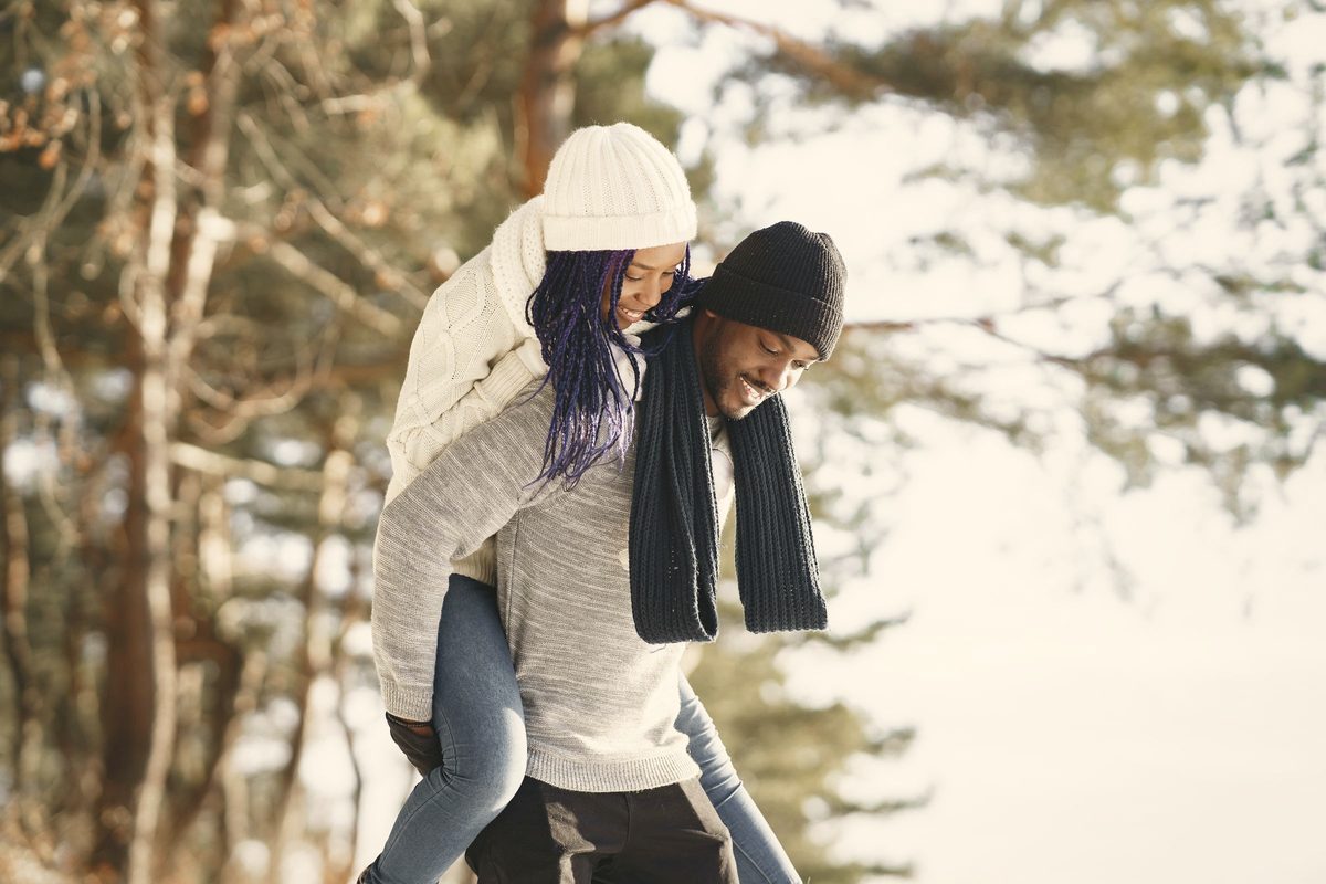 Couple laughing together on a walk in the woods