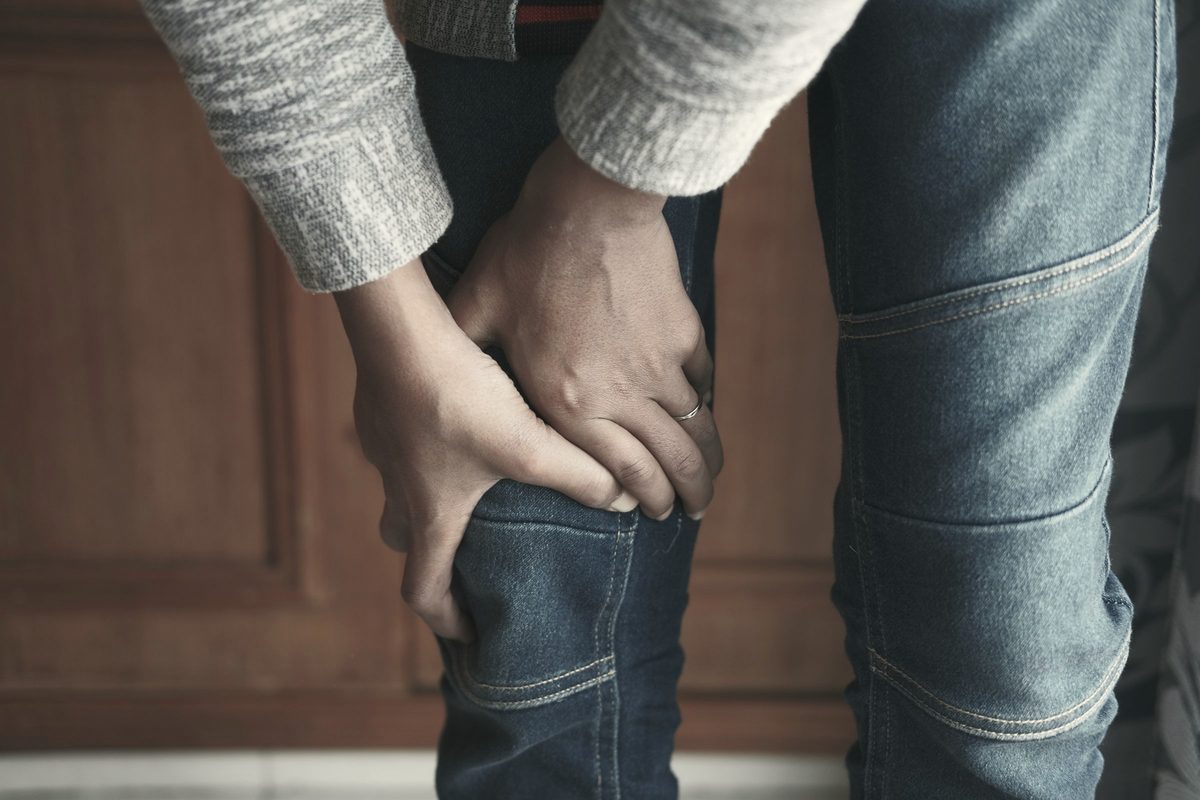 Person holding their knee
