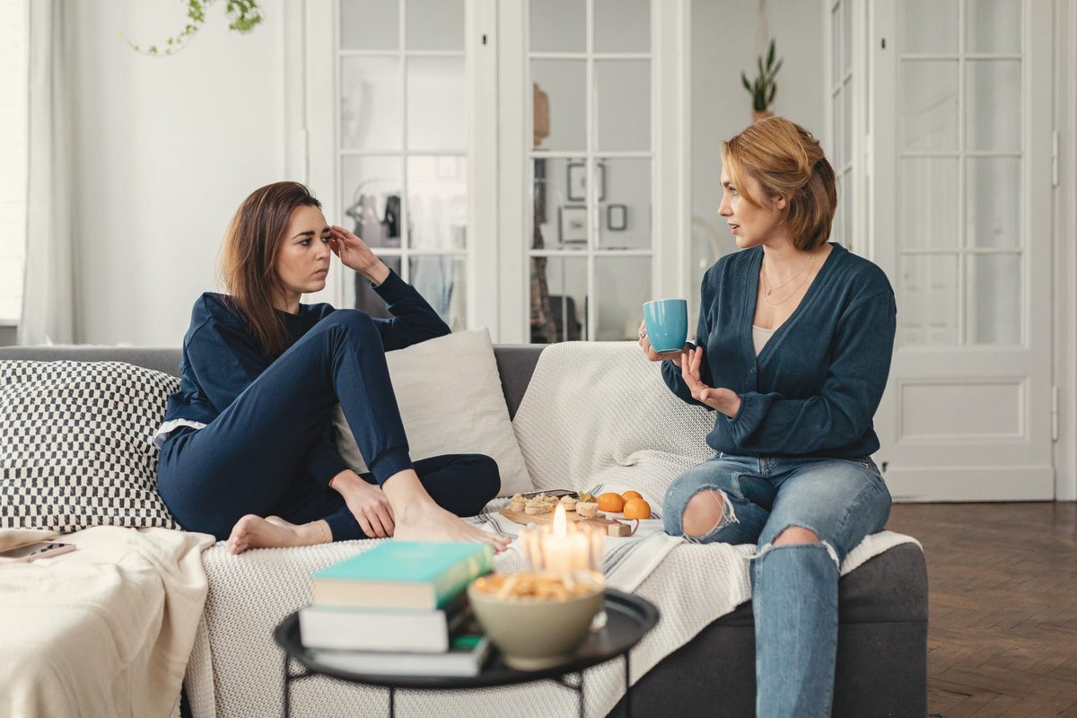 Two women talking together in a living room