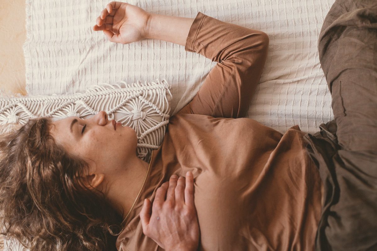 Woman resting on her bed in the afternoon