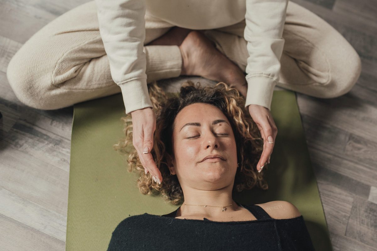Woman resting on a mat with her eyes closed
