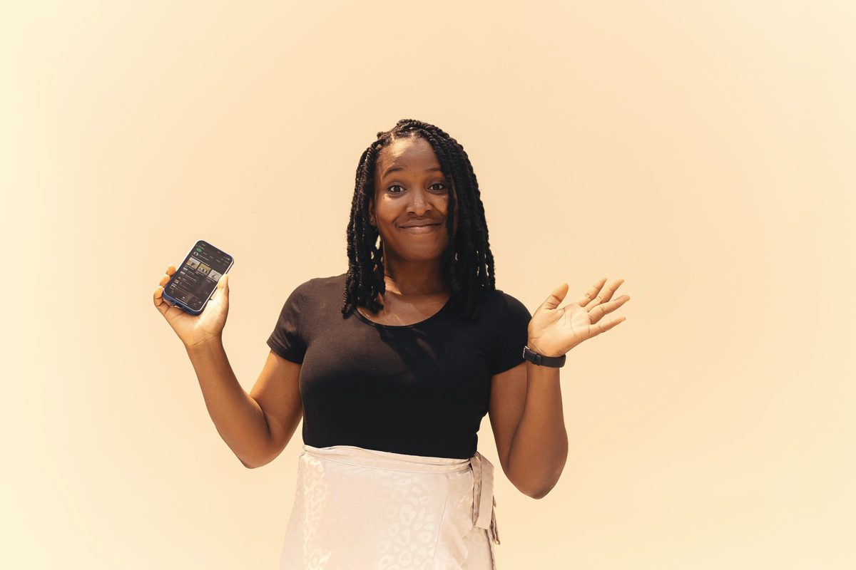 Smiling woman holding her smartphone
