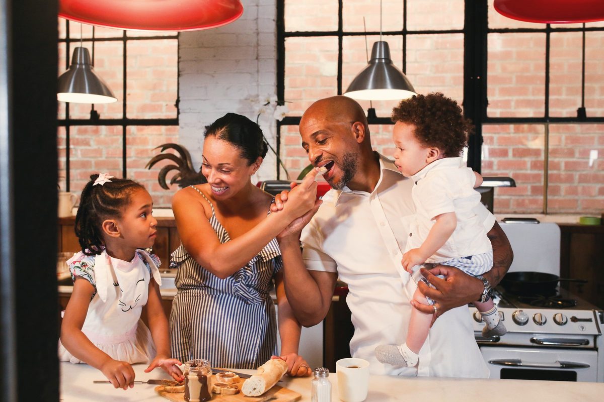 A happy family eating together in a kitchen