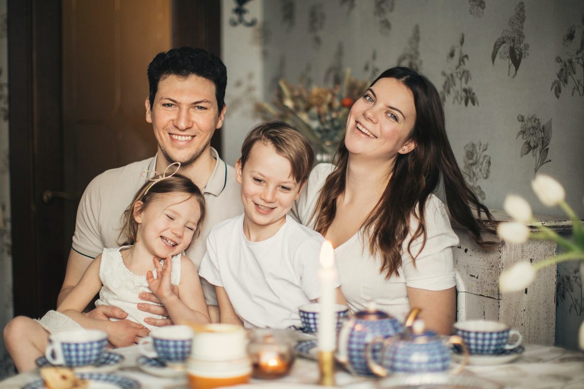 Family laughing together over a cosy meal