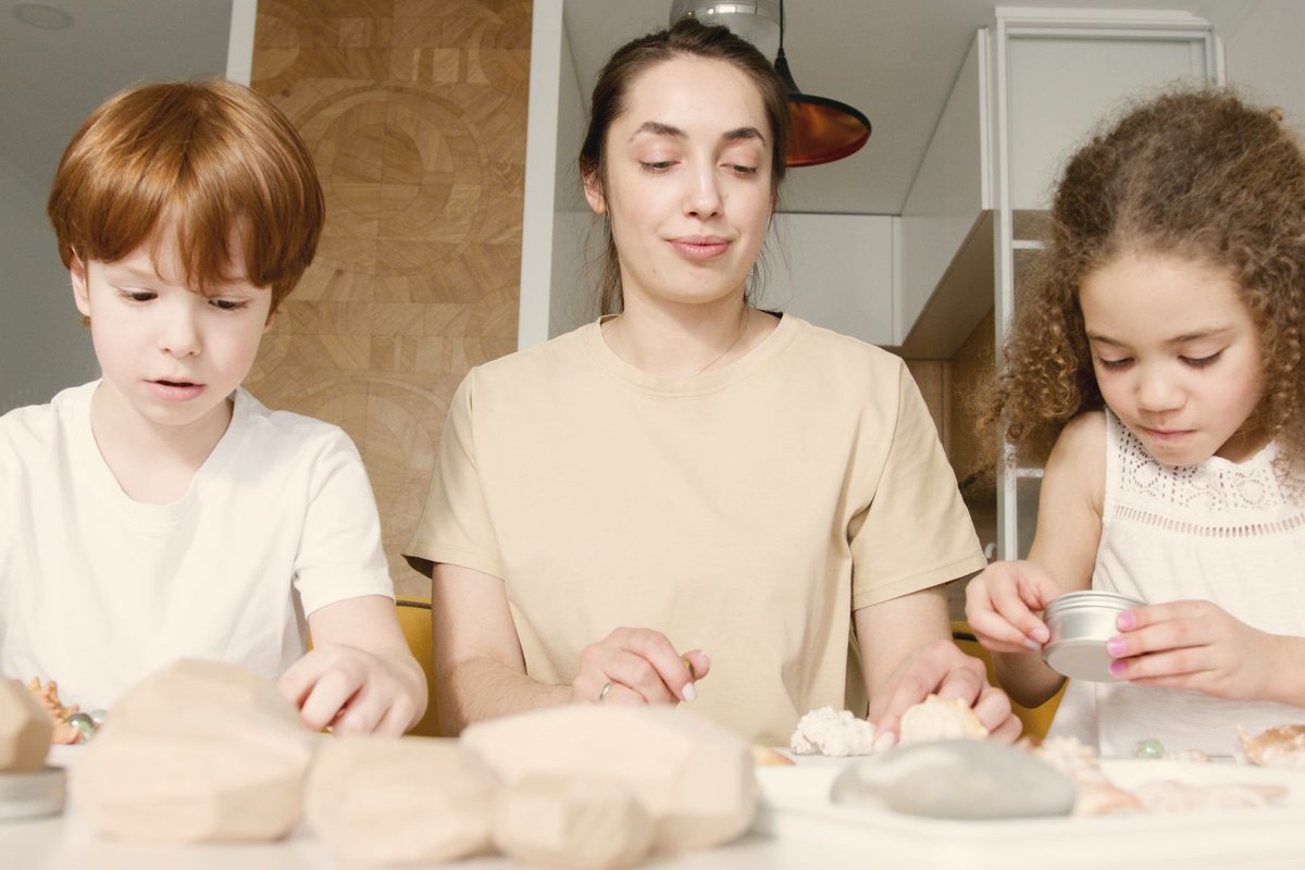 A woman and kids making arts and crafts