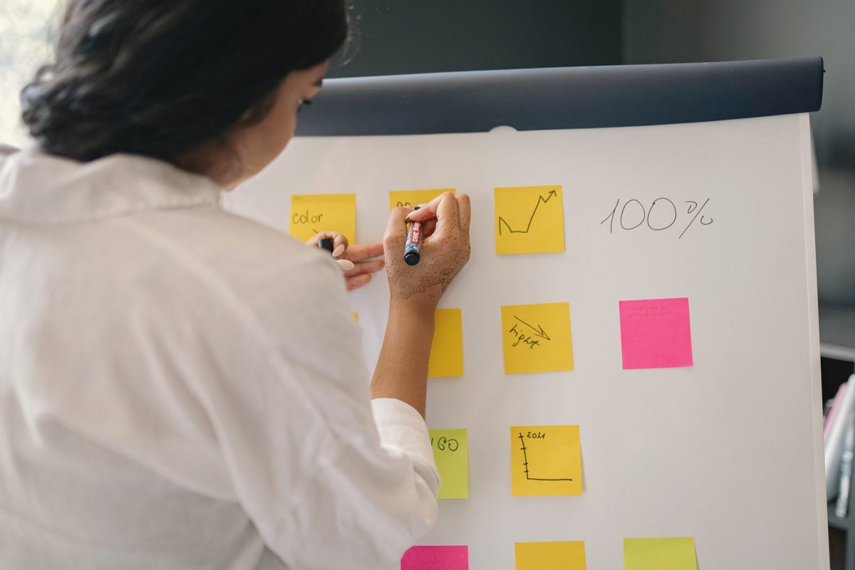 Woman writing on sticky notes