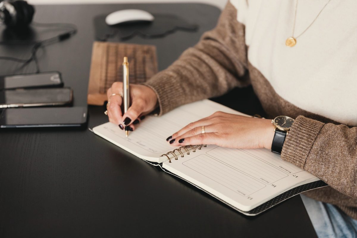 Woman writing notes in her notebook