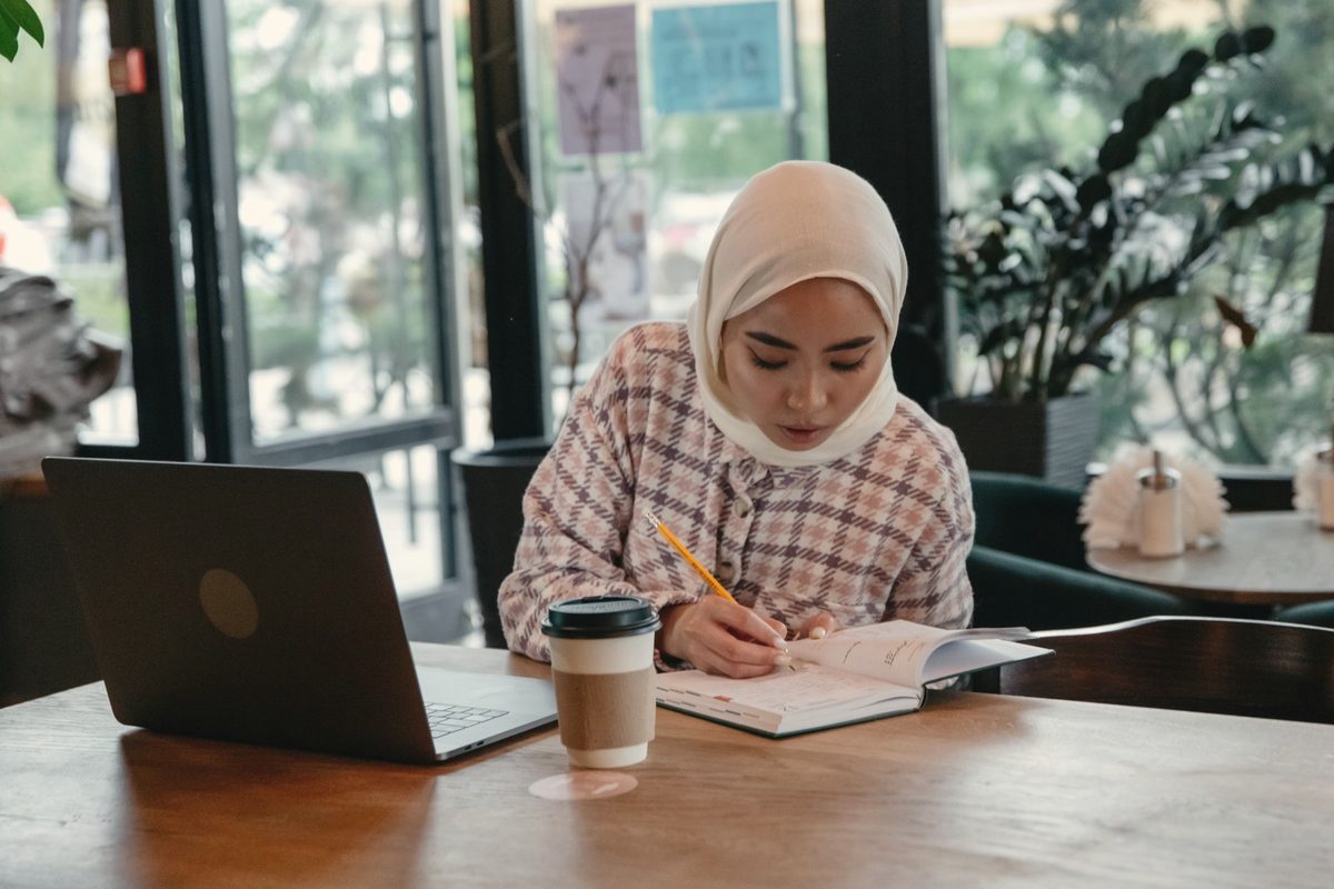 A woman writing at the table