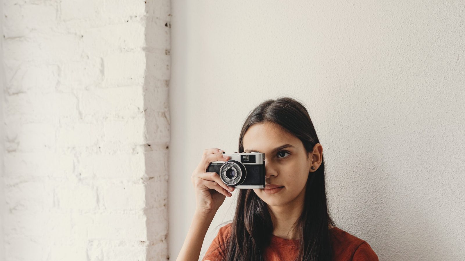 A woman taking photos using a camera
