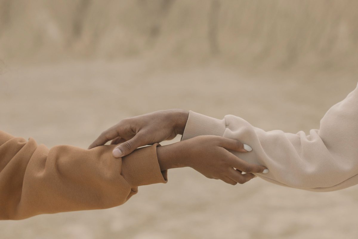 Two people holding hands