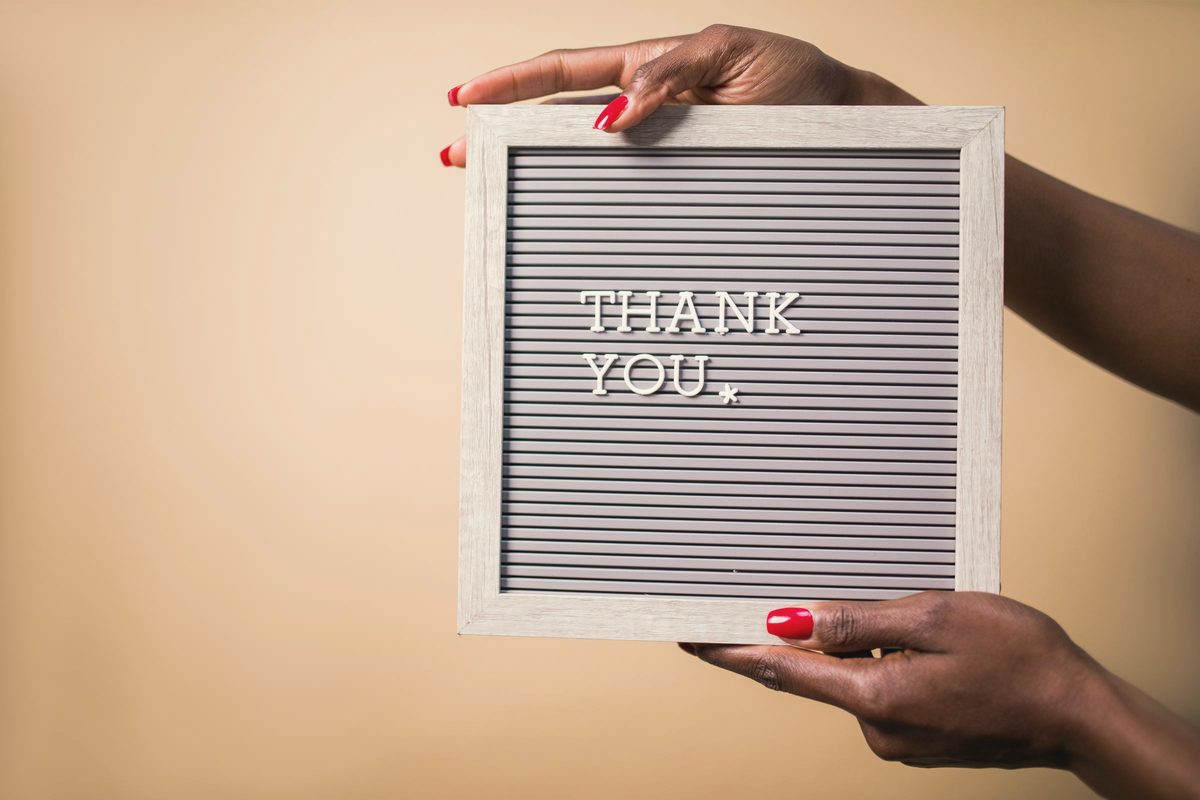 Hands holding a thank you sign