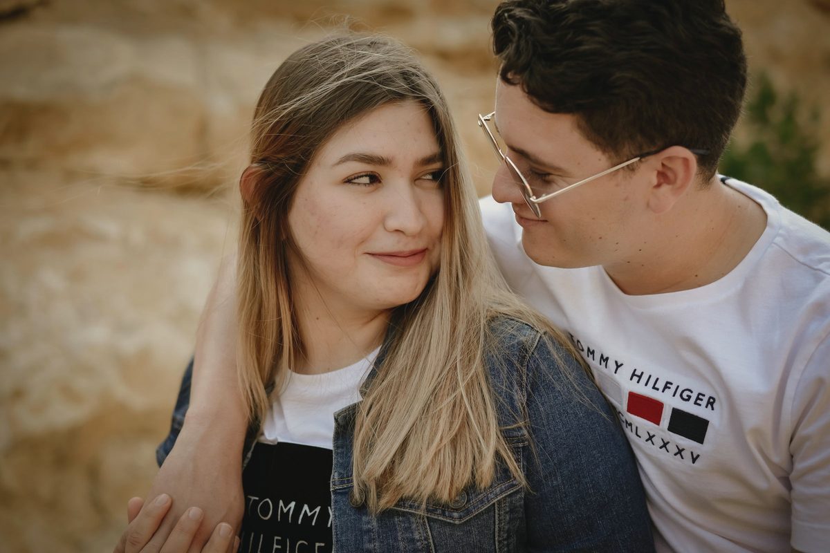 Couple smiling at each other while holding hands