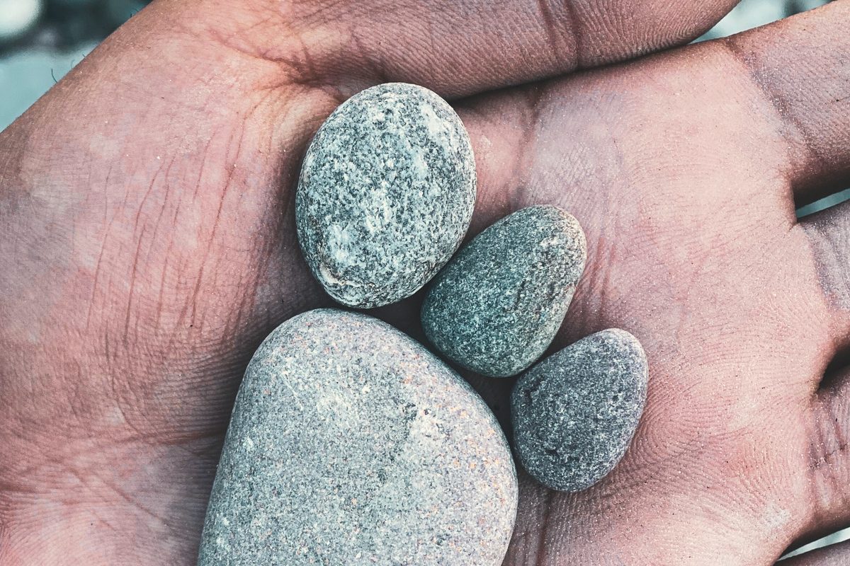 Hand holding rocks