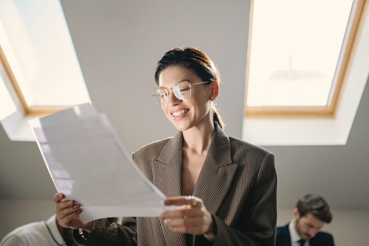 Smiling woman reading a letter