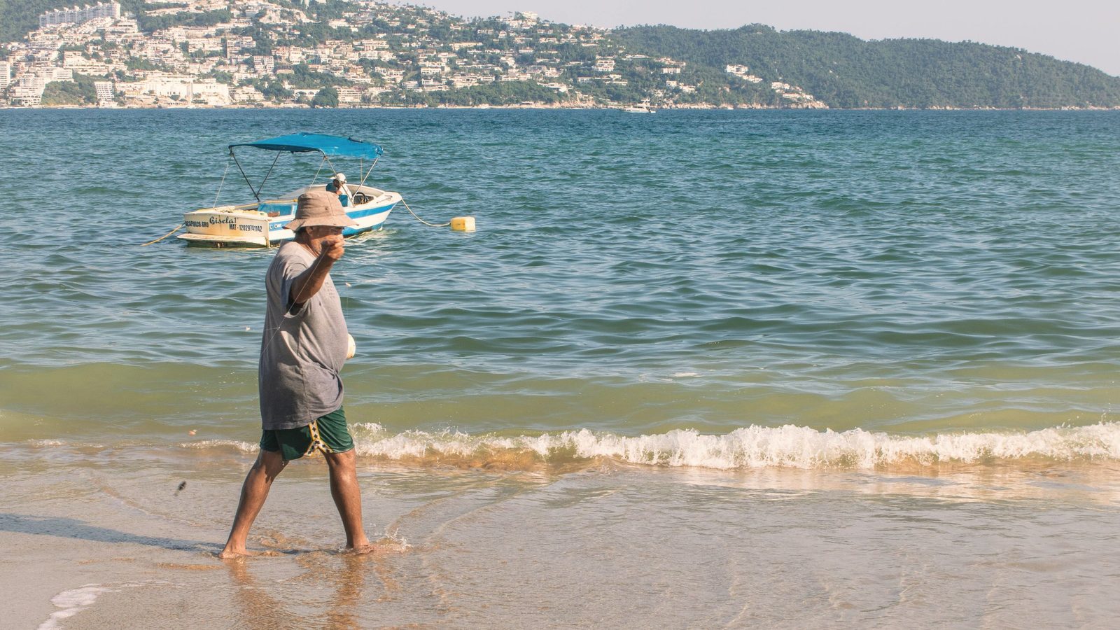 Man walking along the beach shoreline