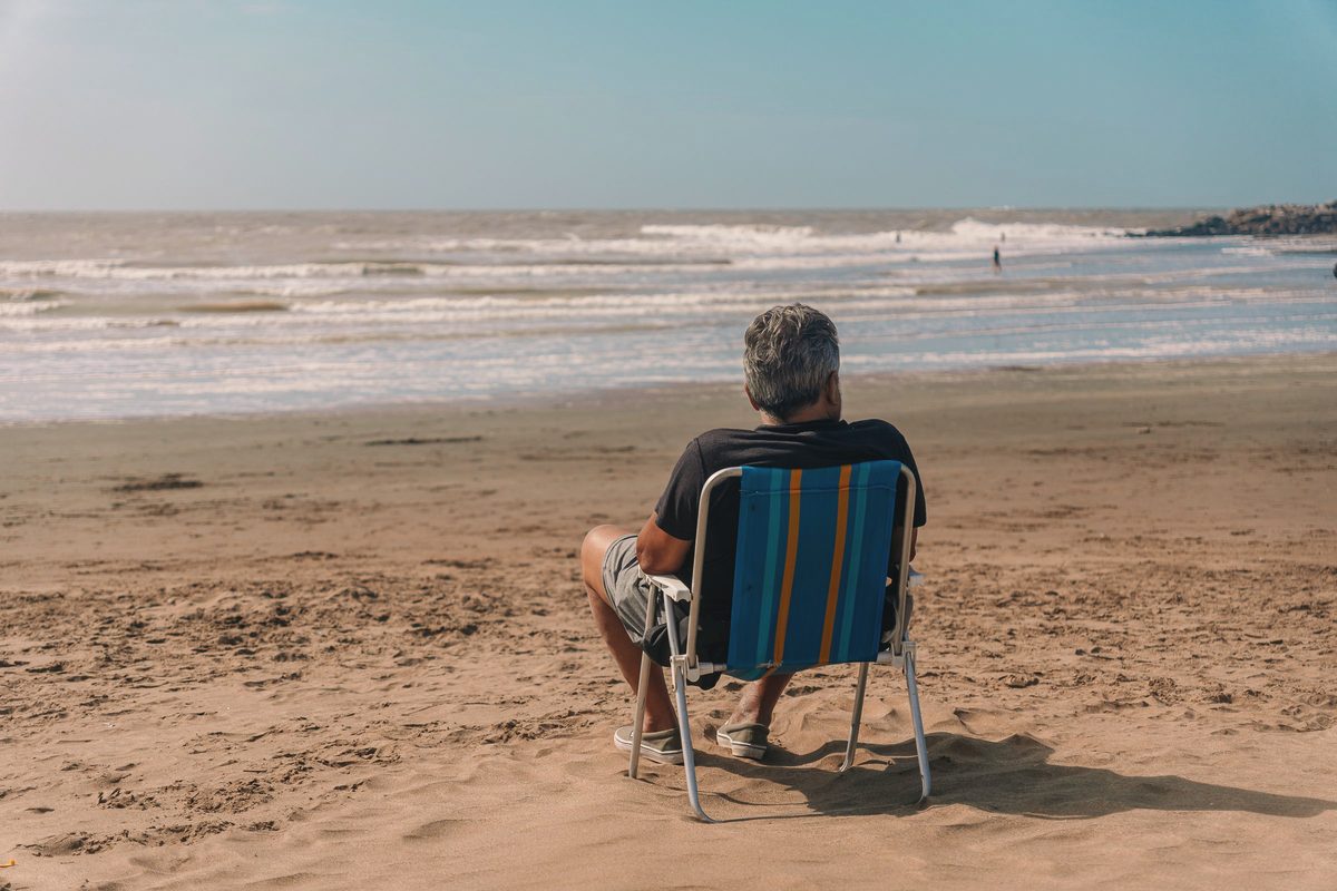 Man relaxing in a beach chair by the ocean