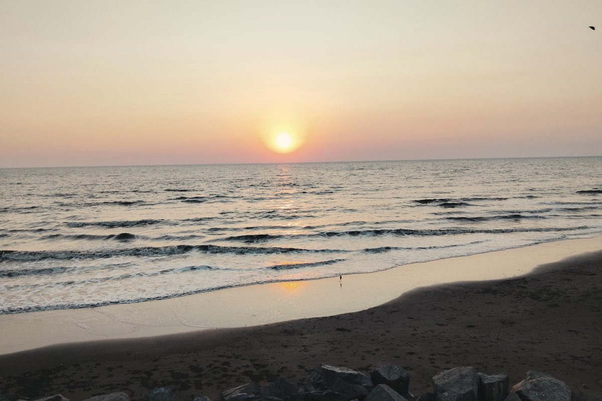 Sunset over calm ocean waves