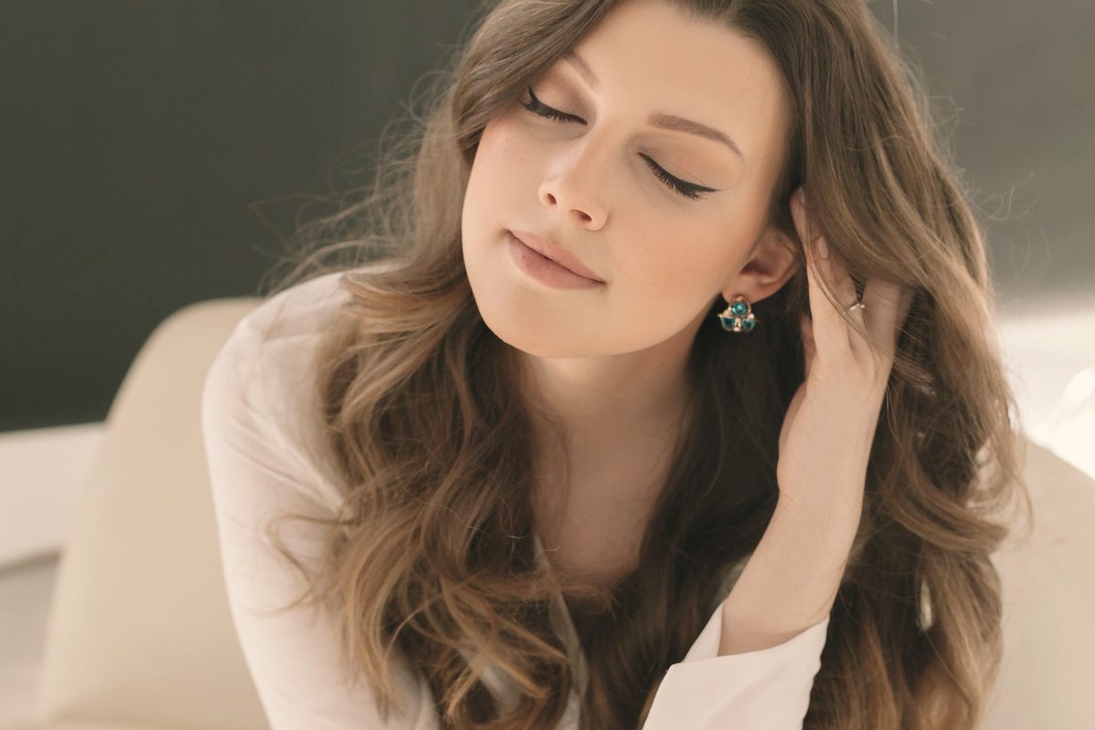 Portrait of woman sitting with eyes closed