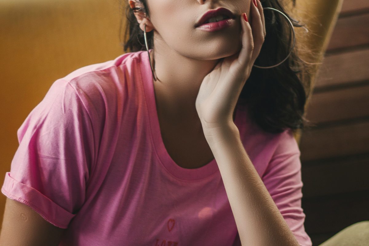 Woman sitting on sofa with eyes closed