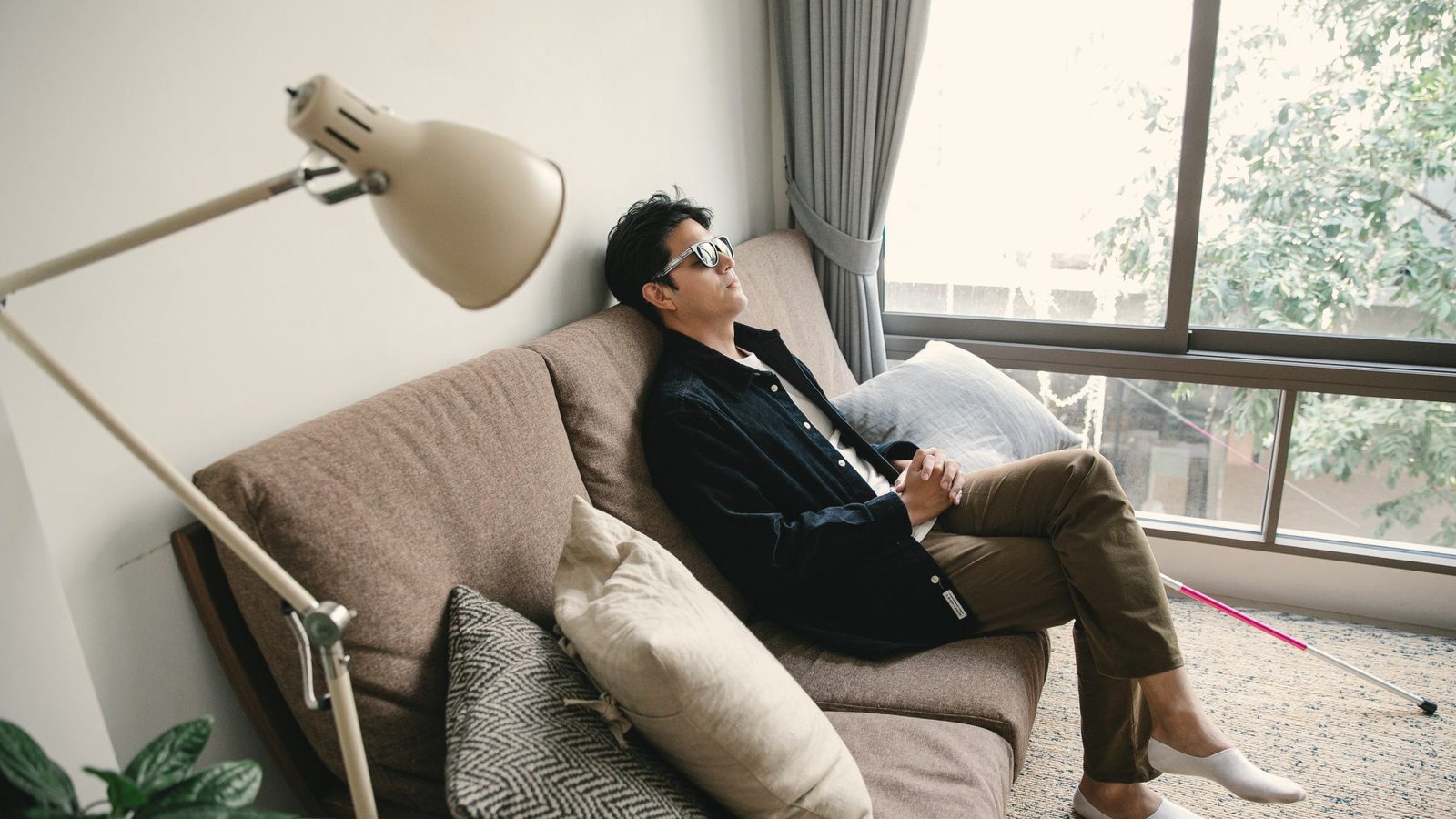 Man resting his head against the wall, looking tired