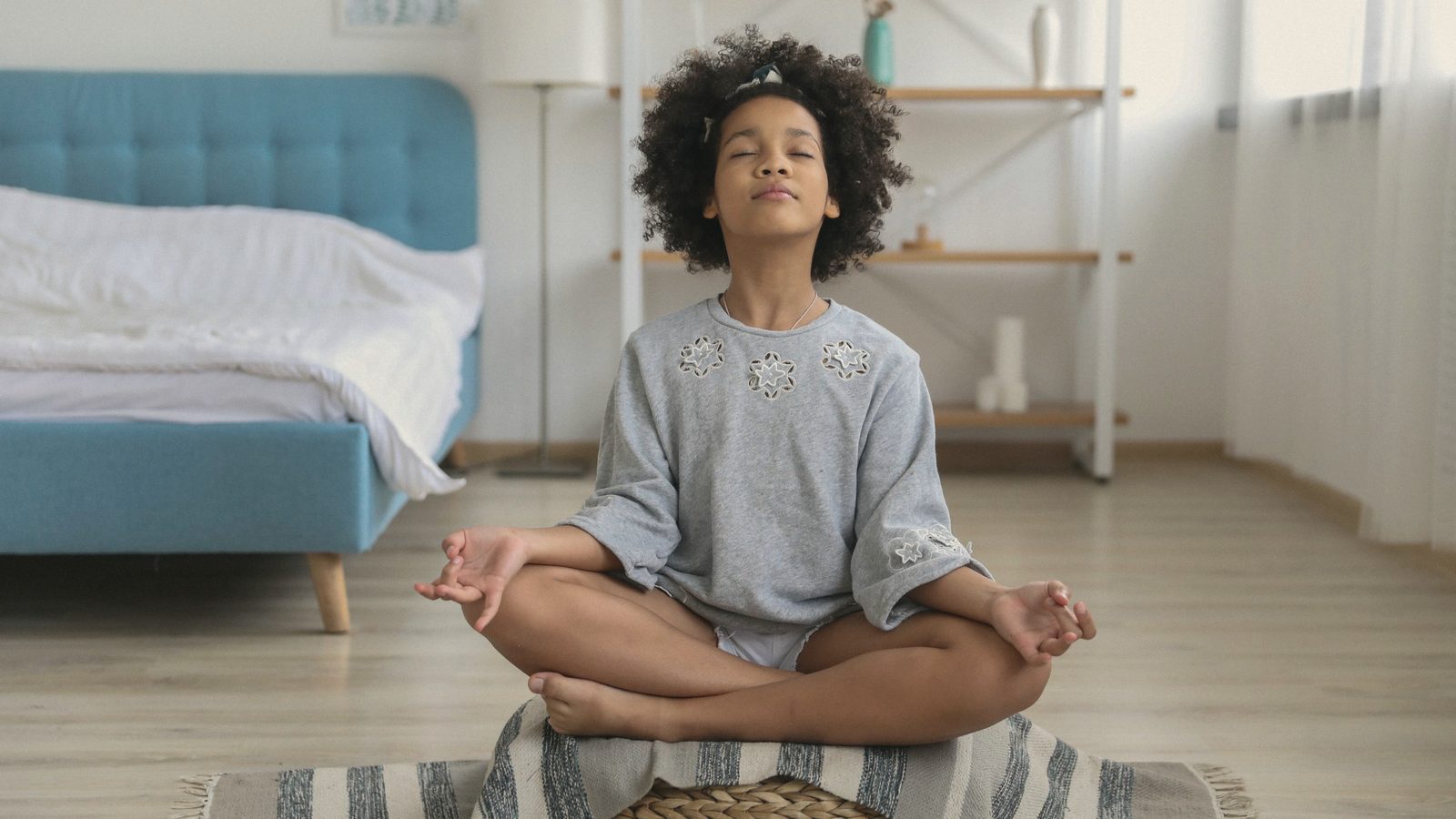 Girl meditating in room with eyes closed