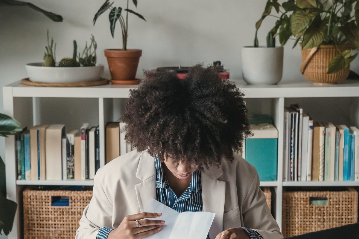 Woman sitting behind a desk and looking through papers
