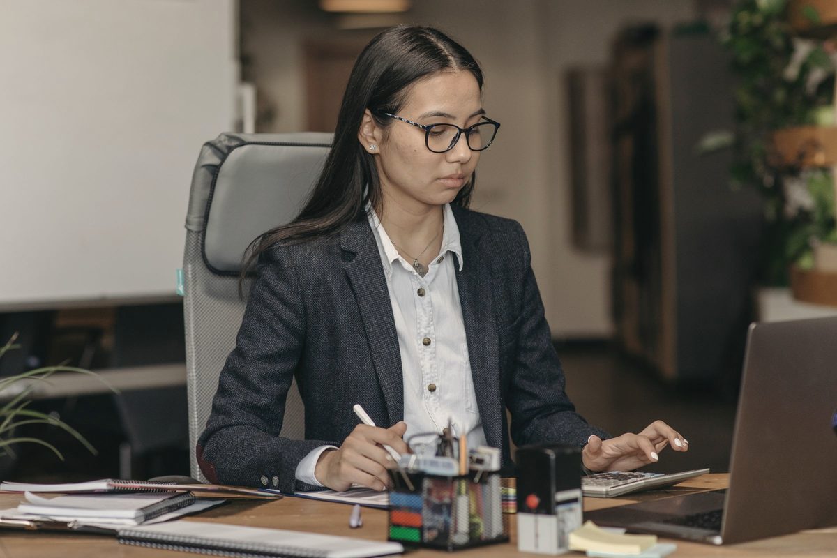 Young woman sitting at the desk in an office and working