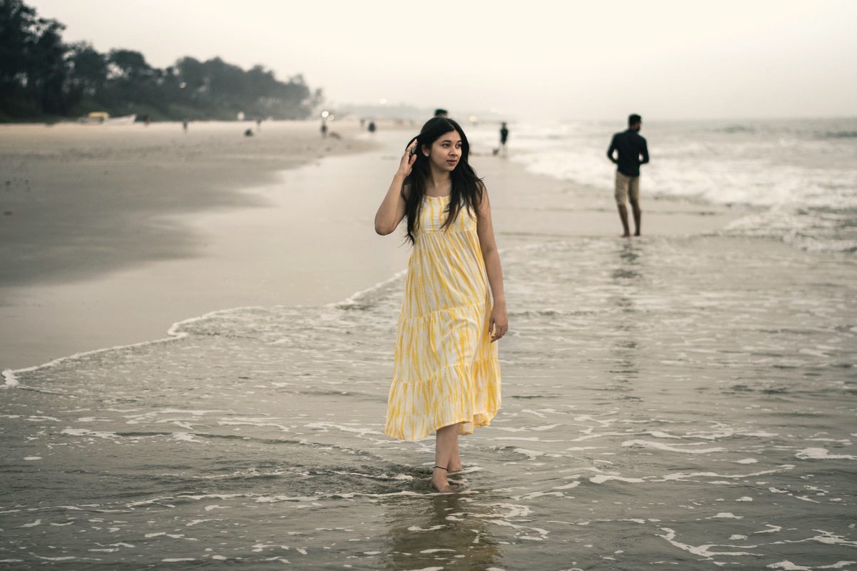 Woman walking slowly along the beach