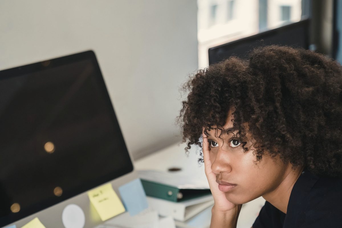 Tired woman resting her head at her work desk
