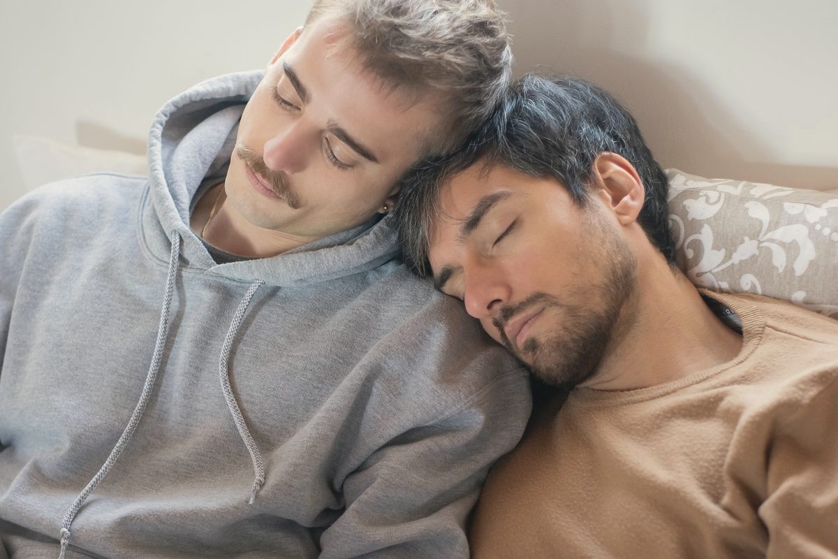 Couple asleep together on the sofa