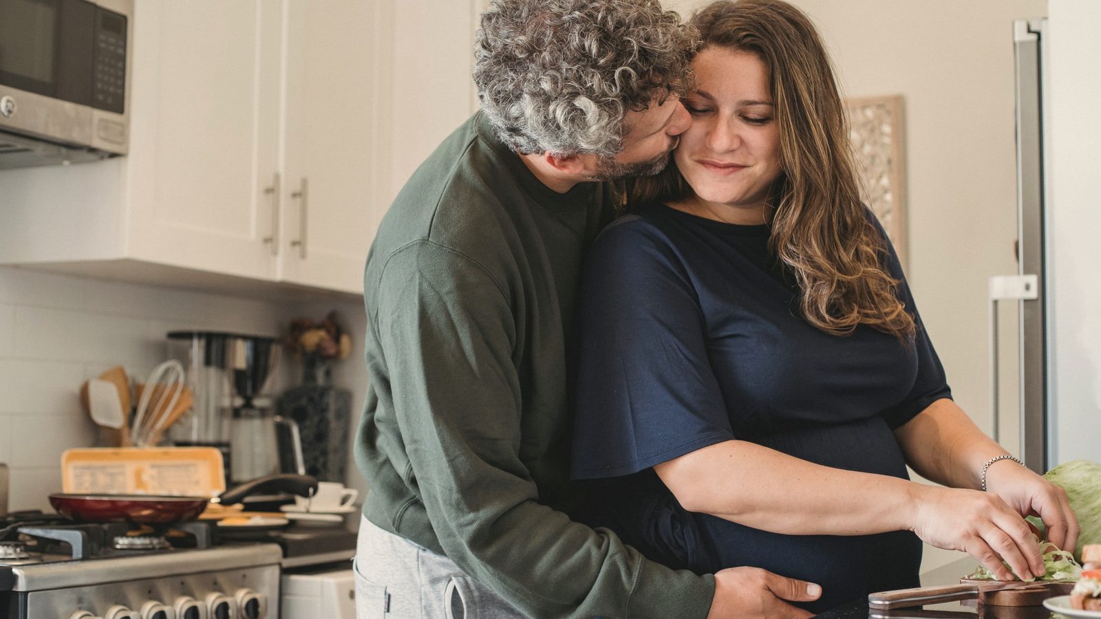 Couple cooking a meal together in their kitchen