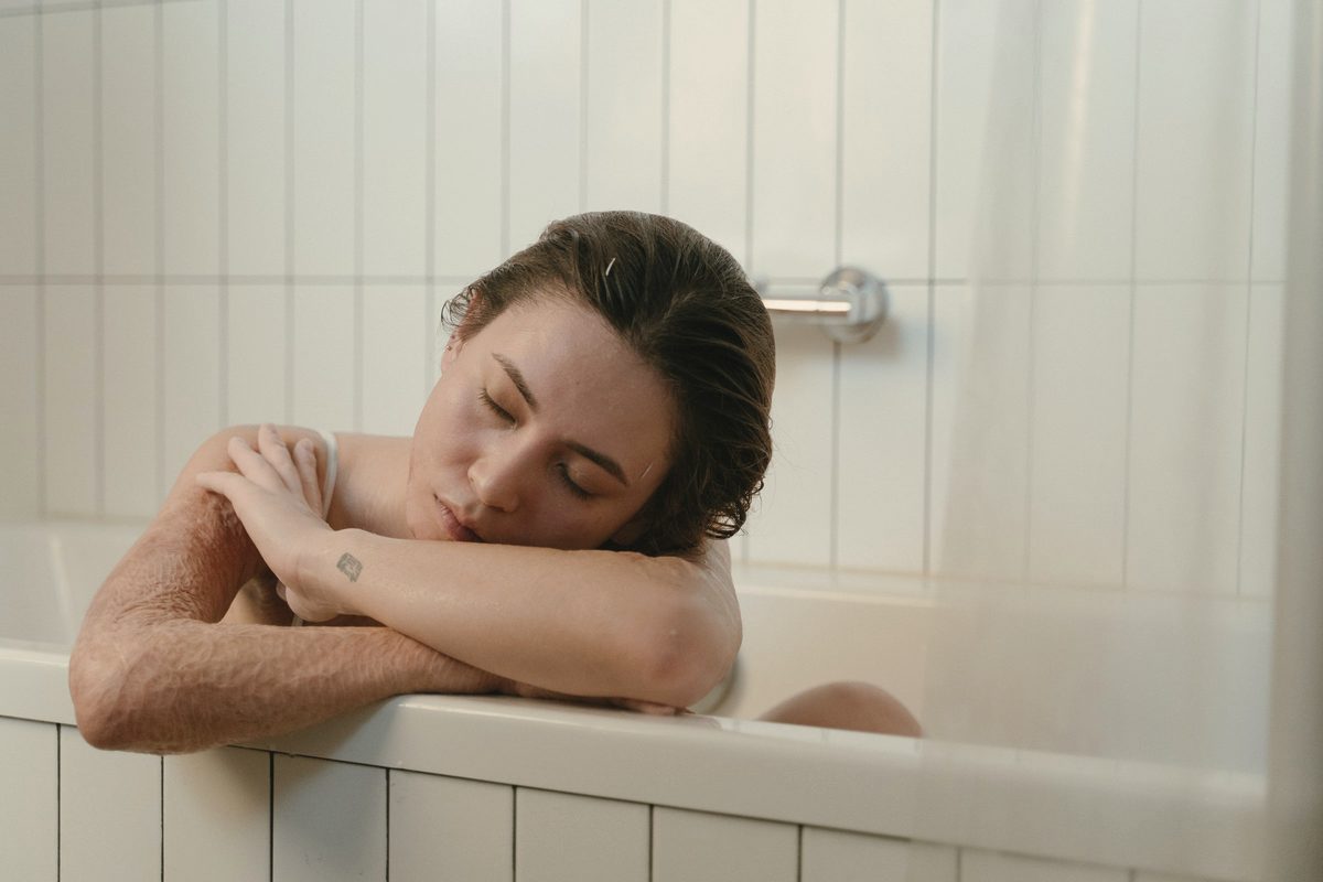 Woman resting with her eyes closed in a bath