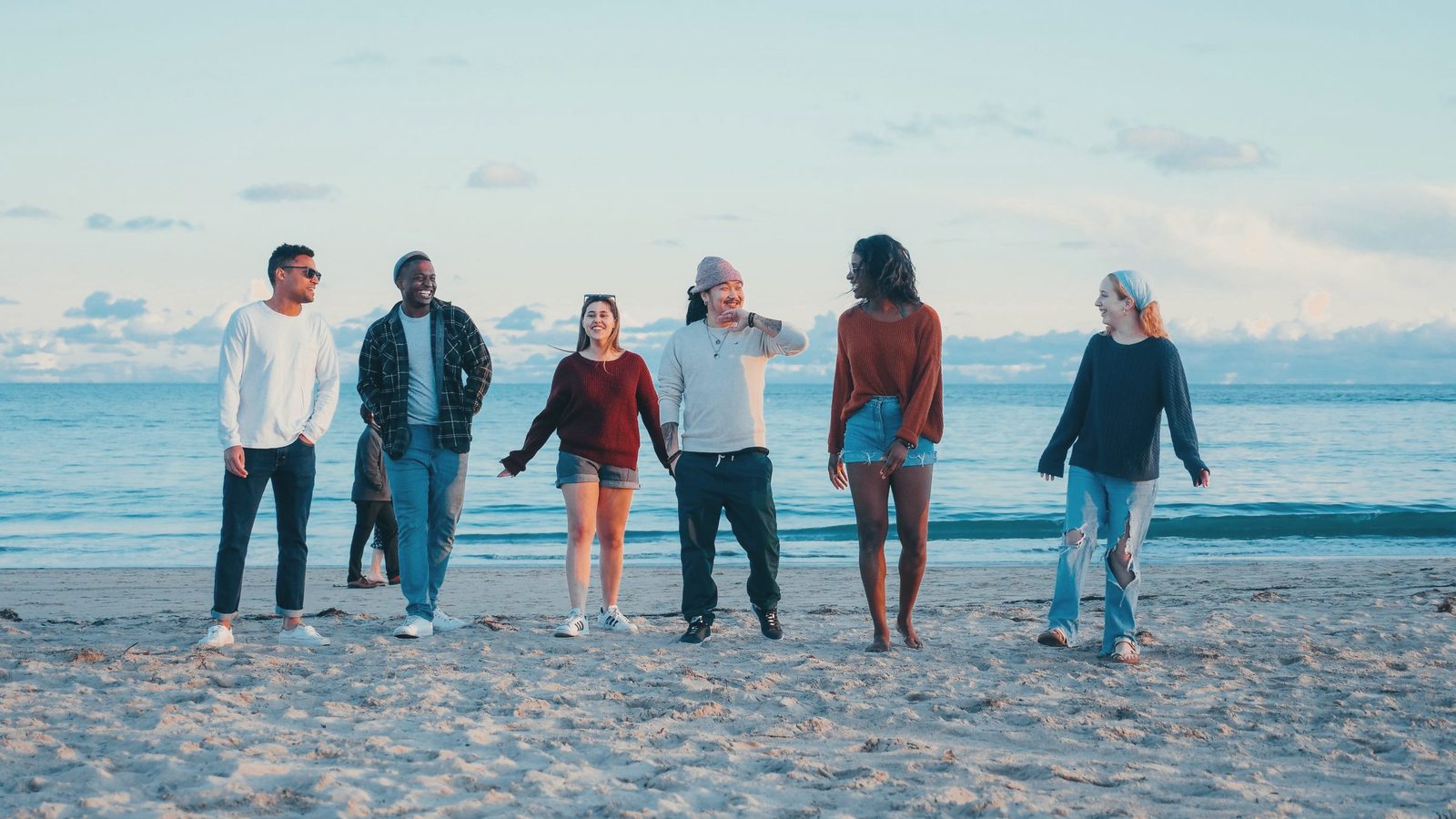 Group of friends walking along the beach